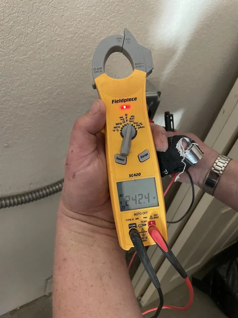Voltage testing with clamp meter during Ceiling Fan Installation in Brownsville